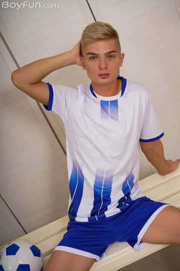 Cute football boy getting naked