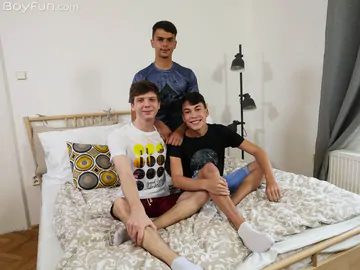 Boys in bed having a threesome