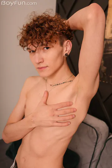 Cute curly redhead playing with his penis