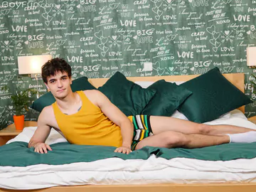 Guy in bed showing stiff dick