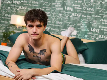 Guy in bed showing stiff dick