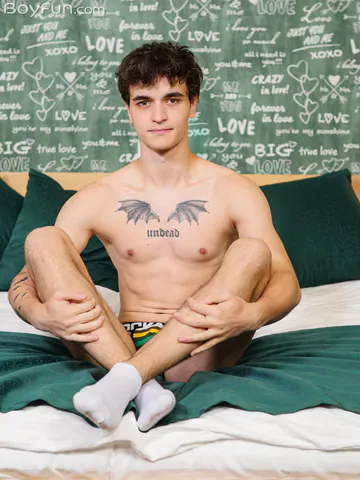 Guy in bed showing stiff dick