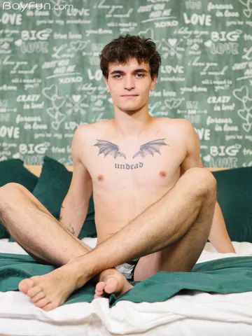 Guy in bed showing stiff dick