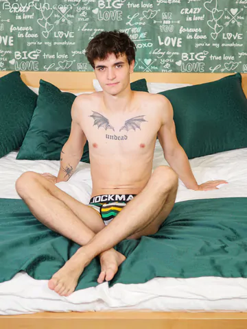 Guy in bed showing stiff dick