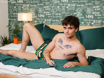 Guy in bed showing stiff dick