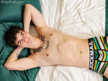 Guy in bed showing stiff dick