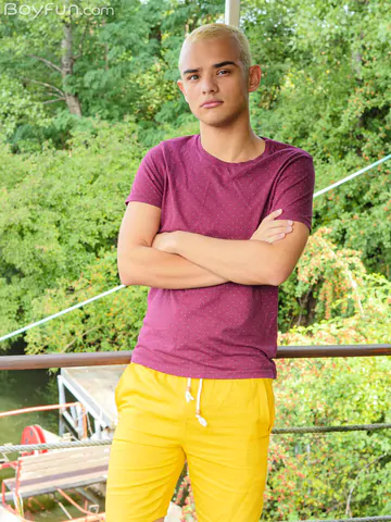 Blonde boy getting naked outdoors