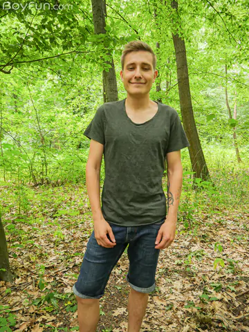 Cute boy getting naked in the forest
