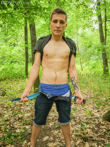 Cute boy getting naked in the forest