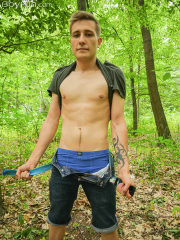 Cute boy getting naked in the forest