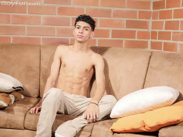 Curly boy with a shaved cock