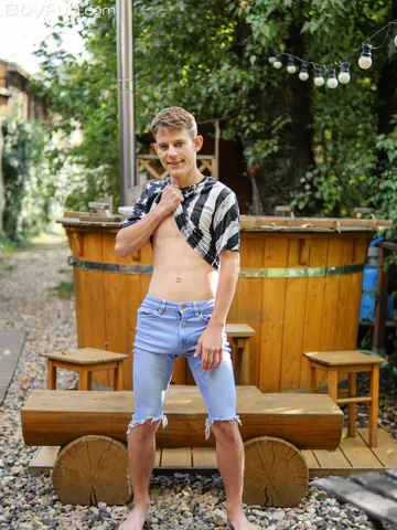 Cute boy getting naked outdoors