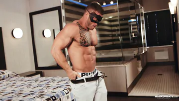 Muscular masked man stripping