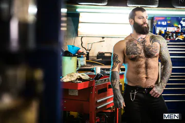 Tattooed guys fucking in a garage