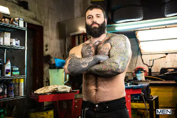 Tattooed guys fucking in a garage