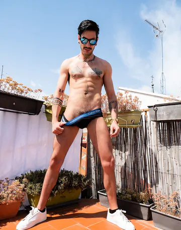 Tattooed guy wanking on a rooftop