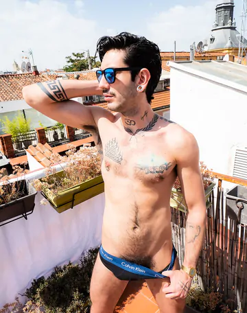 Tattooed guy wanking on a rooftop