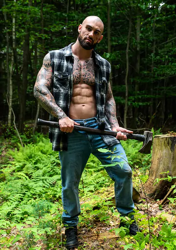Tattooed hunk wanking in the forest