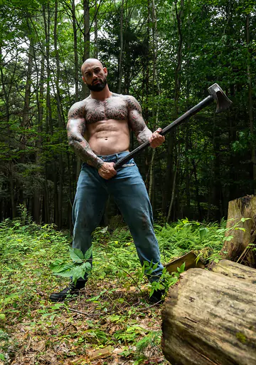 Tattooed hunk wanking in the forest