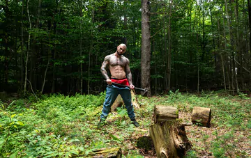 Tattooed hunk wanking in the forest
