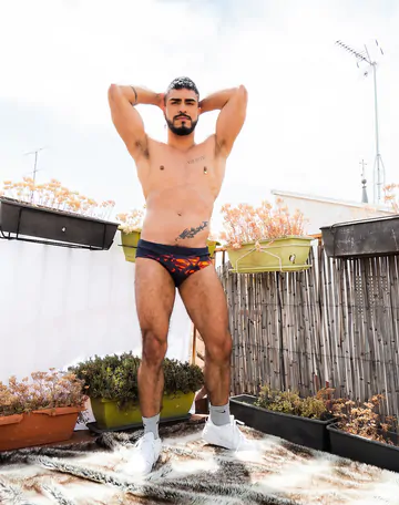 Guy on a rooftop taking a shower
