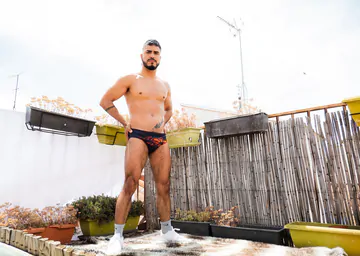Guy on a rooftop taking a shower