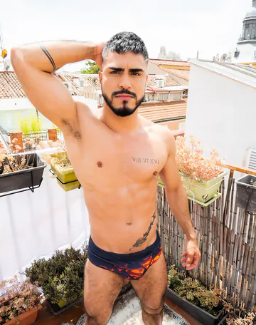 Guy on a rooftop taking a shower