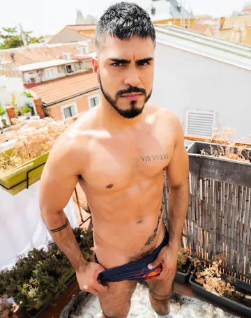 Guy on a rooftop taking a shower