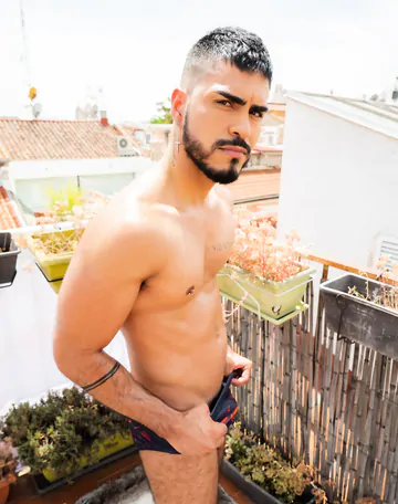 Guy on a rooftop taking a shower