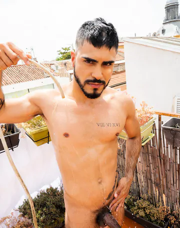Guy on a rooftop taking a shower
