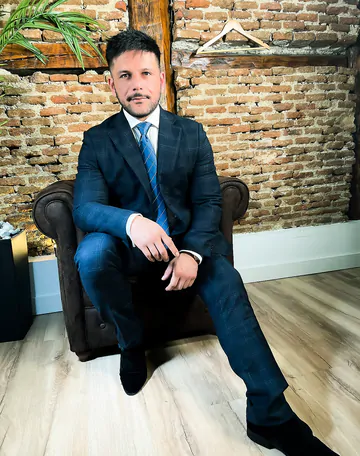 Man in a suit takes his dick out