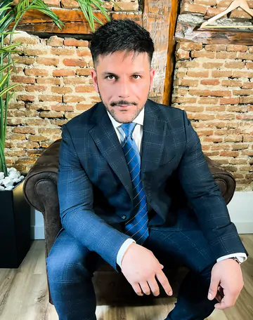 Man in a suit takes his dick out