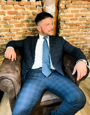 Man in a suit takes his dick out