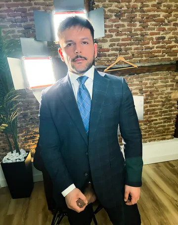 Man in a suit takes his dick out
