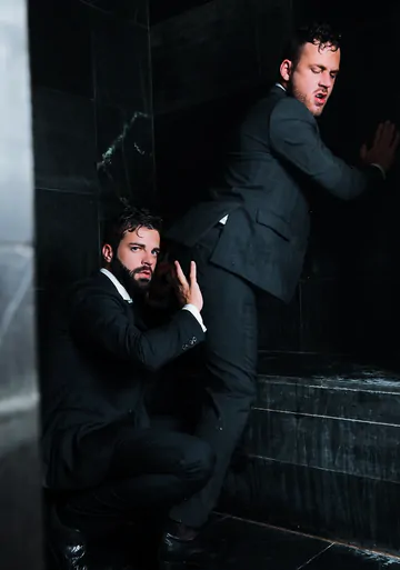 Guys in suits taking a shower