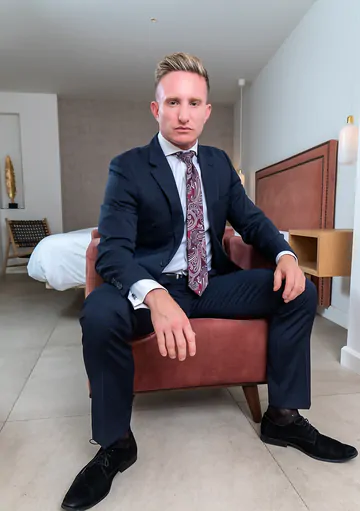 Man in a suit masturbating
