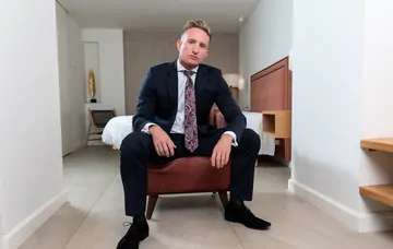 Man in a suit masturbating