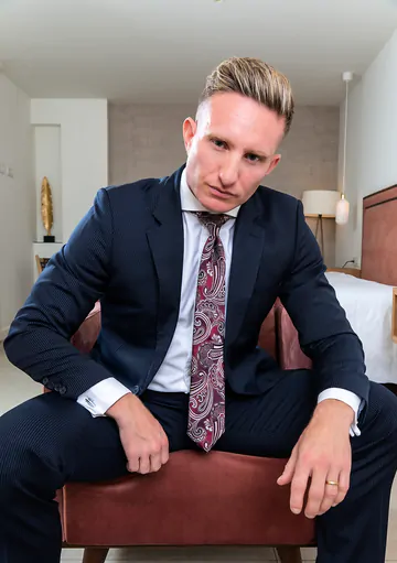 Man in a suit masturbating