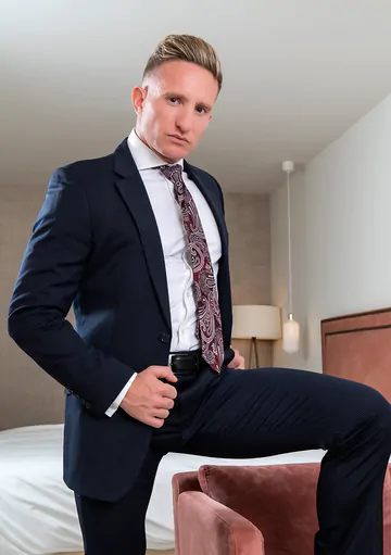 Man in a suit masturbating