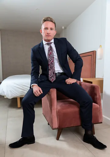 Man in a suit masturbating
