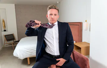 Man in a suit masturbating