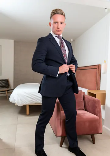 Man in a suit masturbating