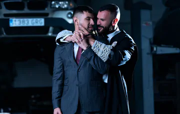 Men in a garage having gay sex