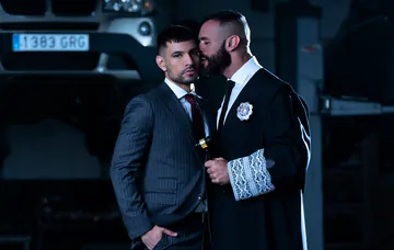 Men in a garage having gay sex