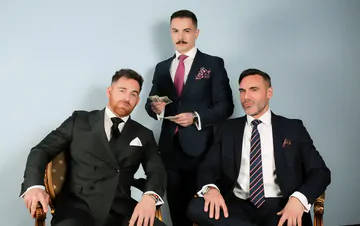 Three guys in suits having sex