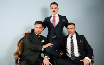 Three guys in suits having sex