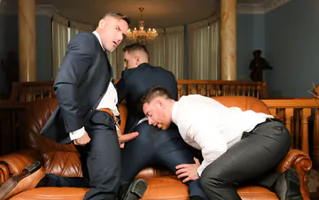 Three guys in suits having sex
