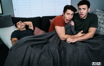 Guys in bed having a threesome