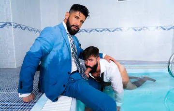 Clothed men fucking in a hottub
